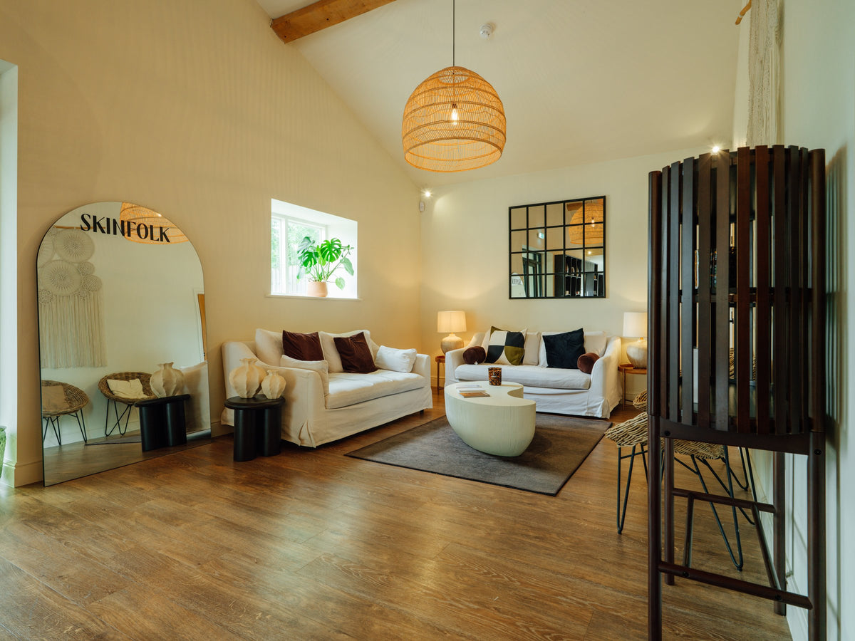 The Skinfolk lounge with branded arch mirror and seating