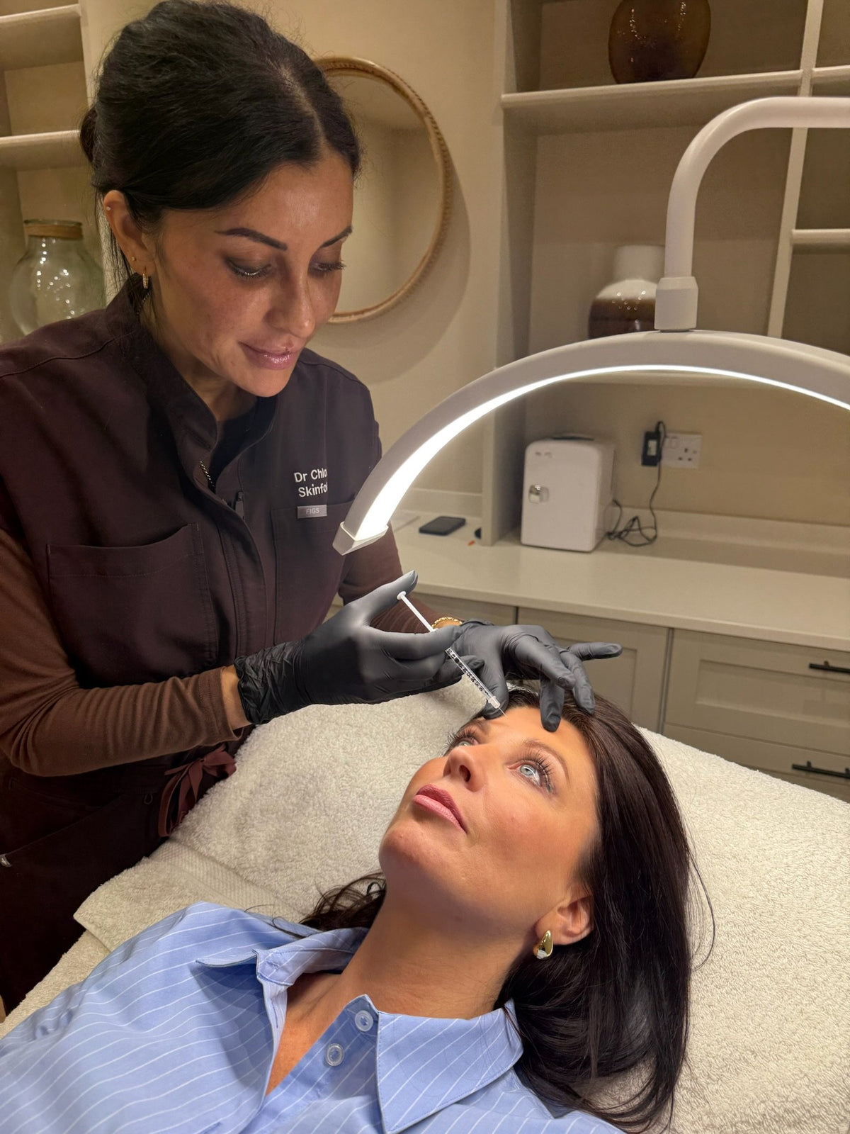 Facial treatment under clinic lighting at Skinfolk